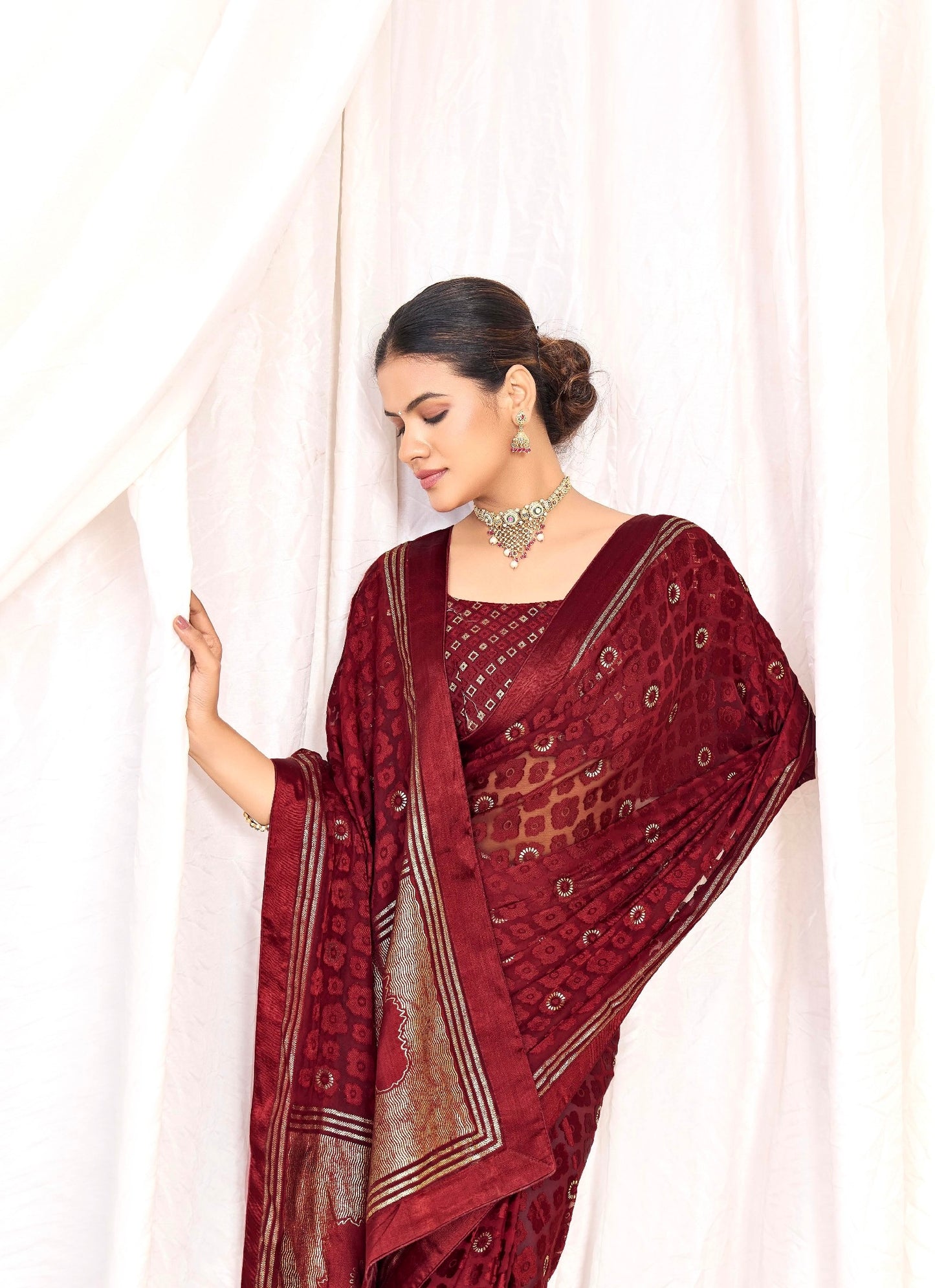 Pure Brasso fabric with Exclusive Wine colored Designed with Featuring Interactive Silver Foil Touch with Rich Traditional Border Ideal for Day to Evening Events.