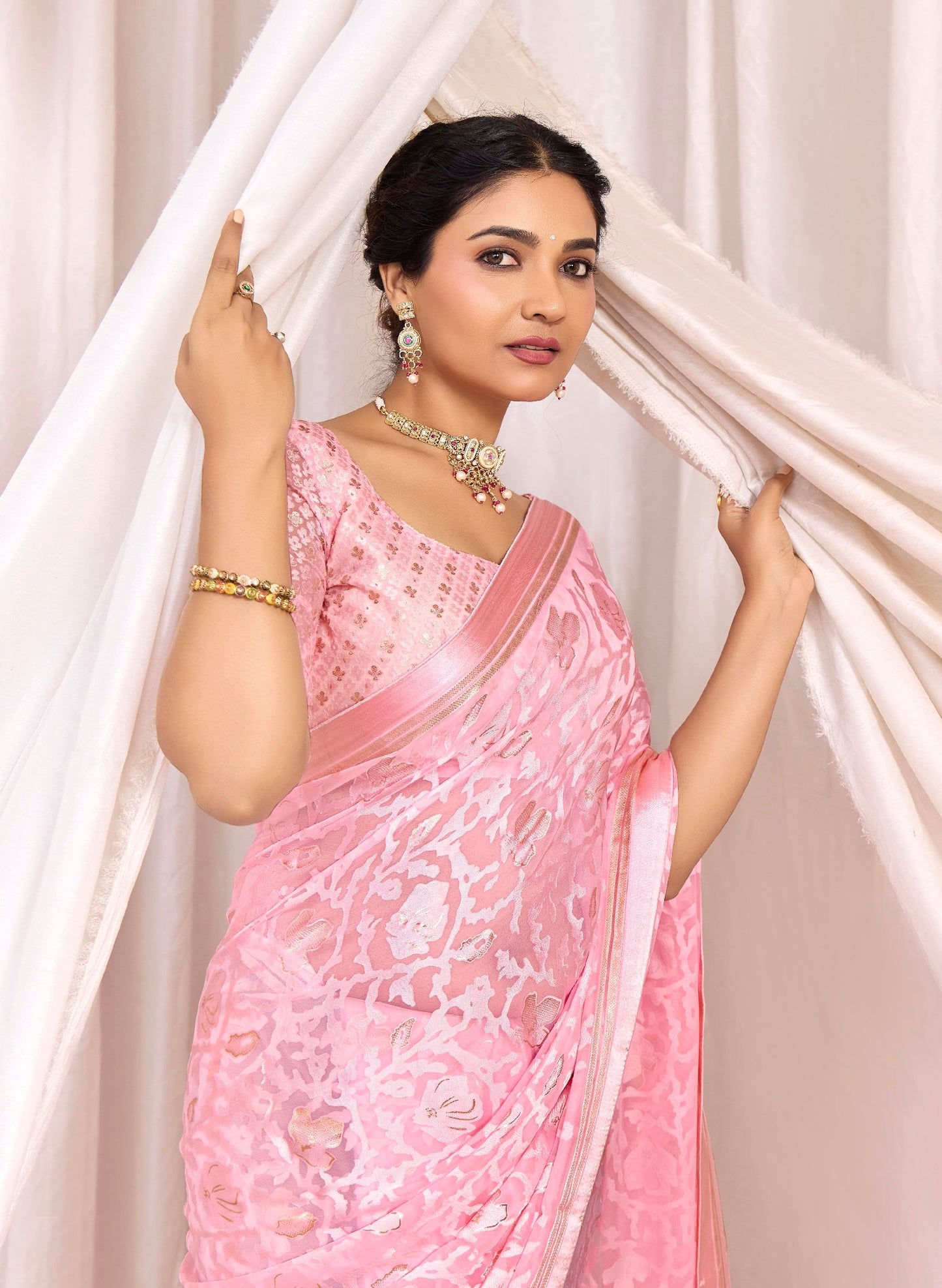 Pure Brasso fabric with Exclusive Baby Pink colored Designed with Featuring Interactive Gold & Silver Foil Touch with Rich Traditional Border Ideal for Day to Evening Events.