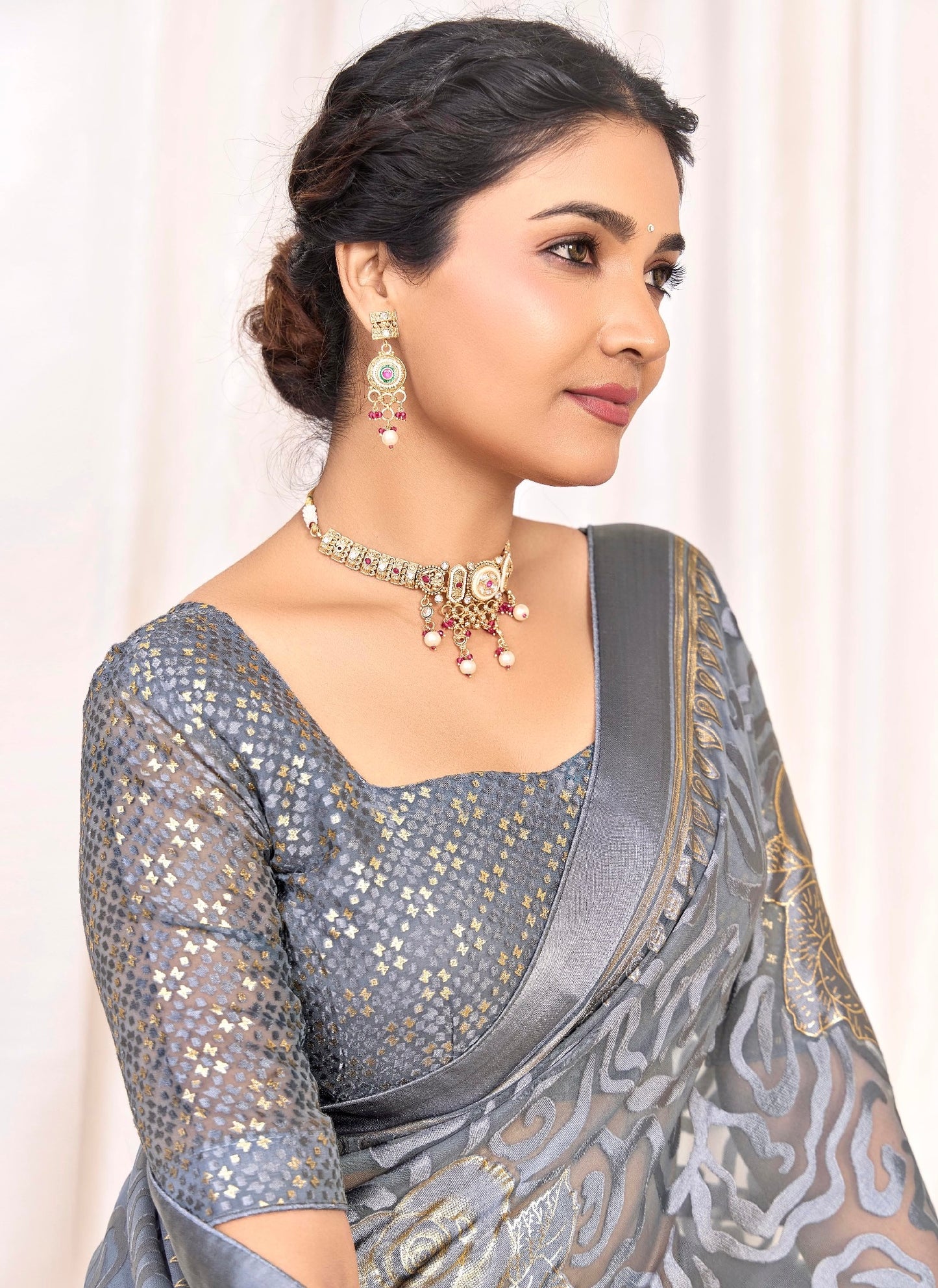 Pure Brasso fabric with Exclusive Metallic Grey colored Designed with Featuring Interactive Gold & Silver Foil Touch with Rich Traditional Border Ideal for Day to Evening Events.