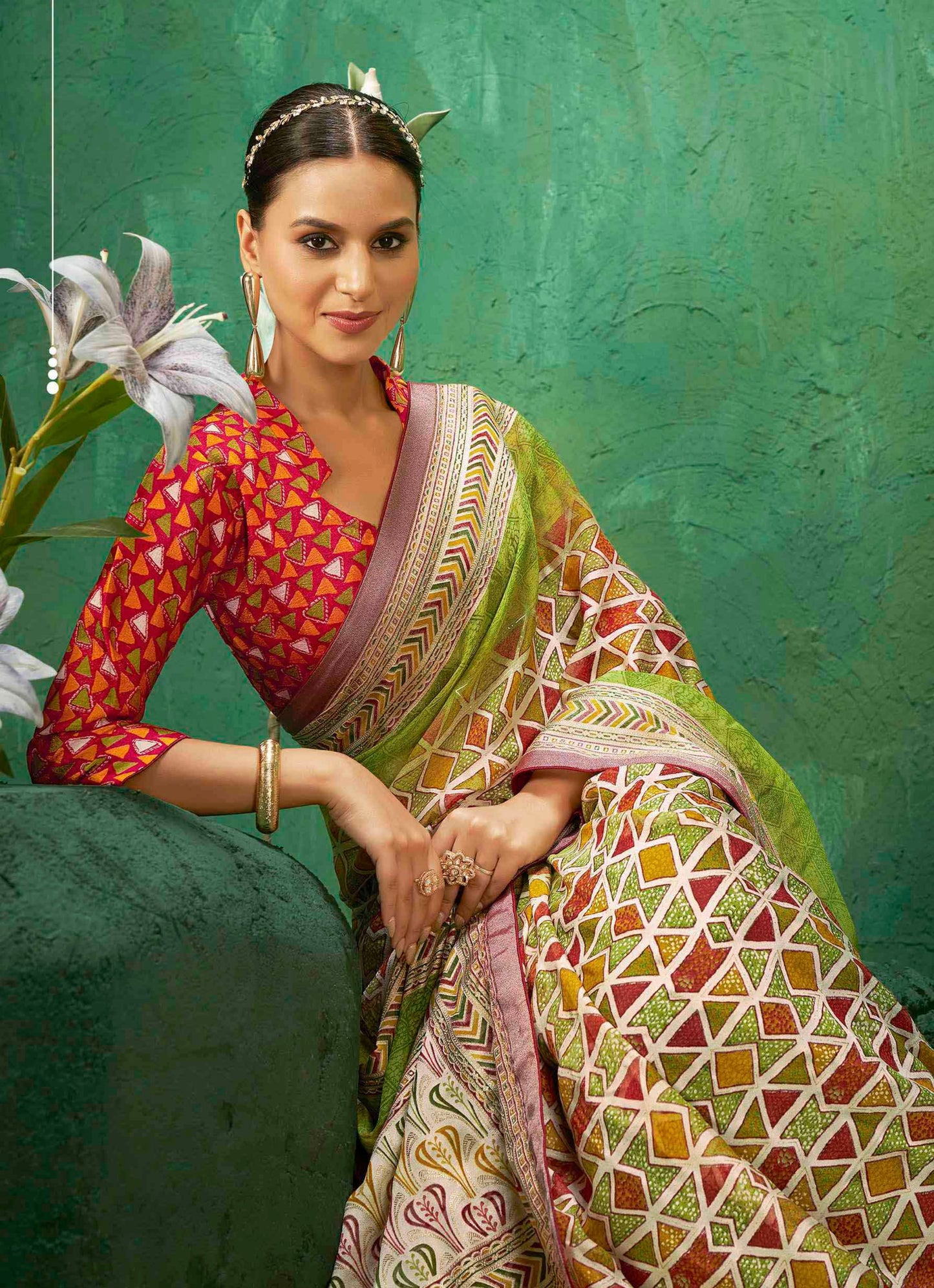 Exclusive Brasso fabric with Vibrant Green color combination adorned with Multi-color Geometric Patterns  with an Ornate Border for festive celebrations and statement ethnic style.