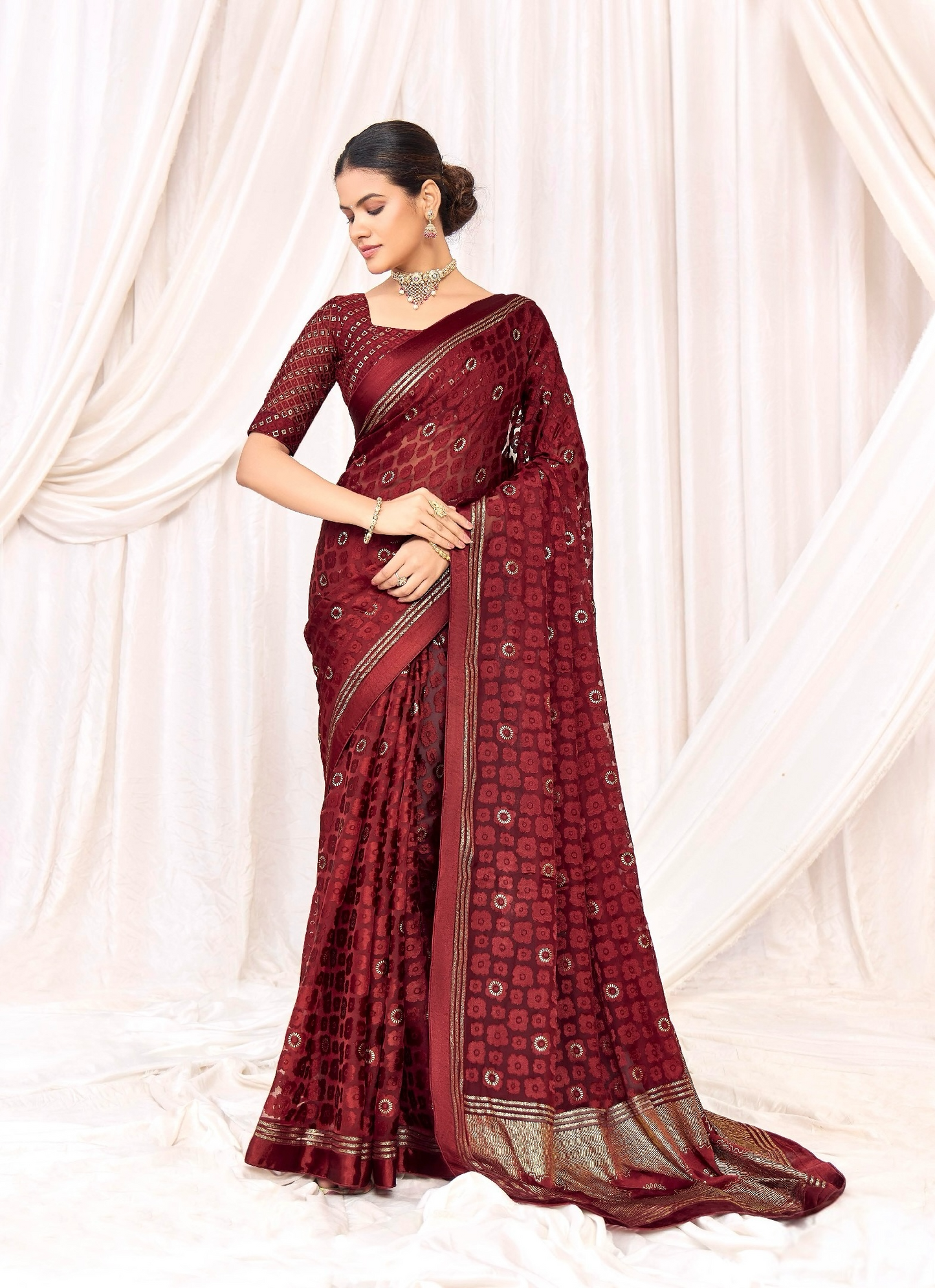 Pure Brasso fabric with Exclusive Wine colored Designed with Featuring Interactive Silver Foil Touch with Rich Traditional Border Ideal for Day to Evening Events.