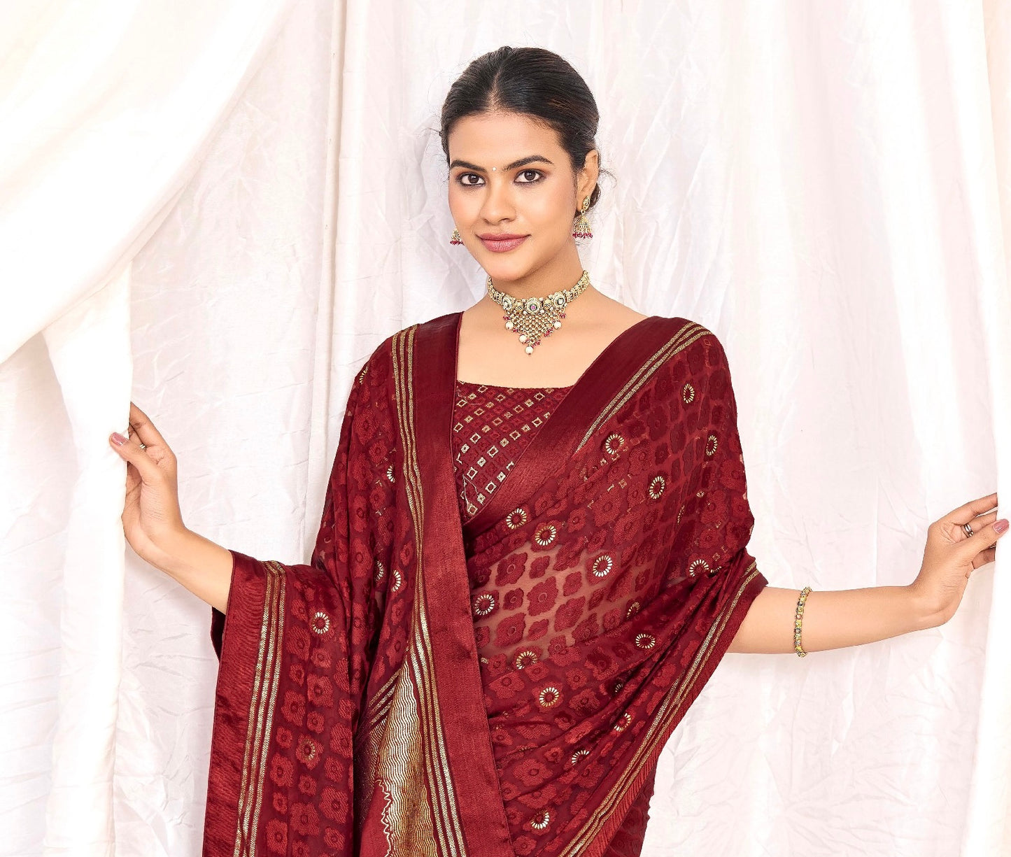 Pure Brasso fabric with Exclusive Wine colored Designed with Featuring Interactive Silver Foil Touch with Rich Traditional Border Ideal for Day to Evening Events.