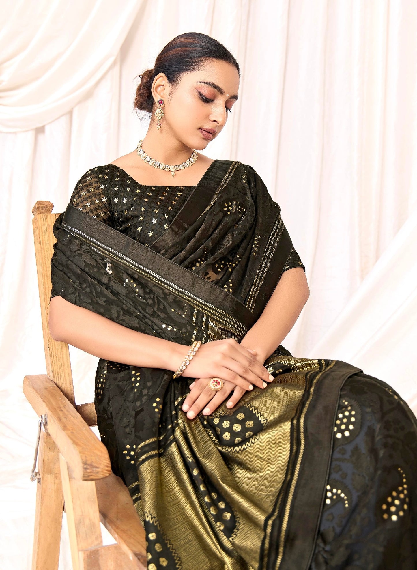 Pure Brasso fabric with Exclusive Charcoal colored Designed with Featuring Interactive Gold Foil Touch with Rich Traditional Border Ideal for Day to Evening Events.