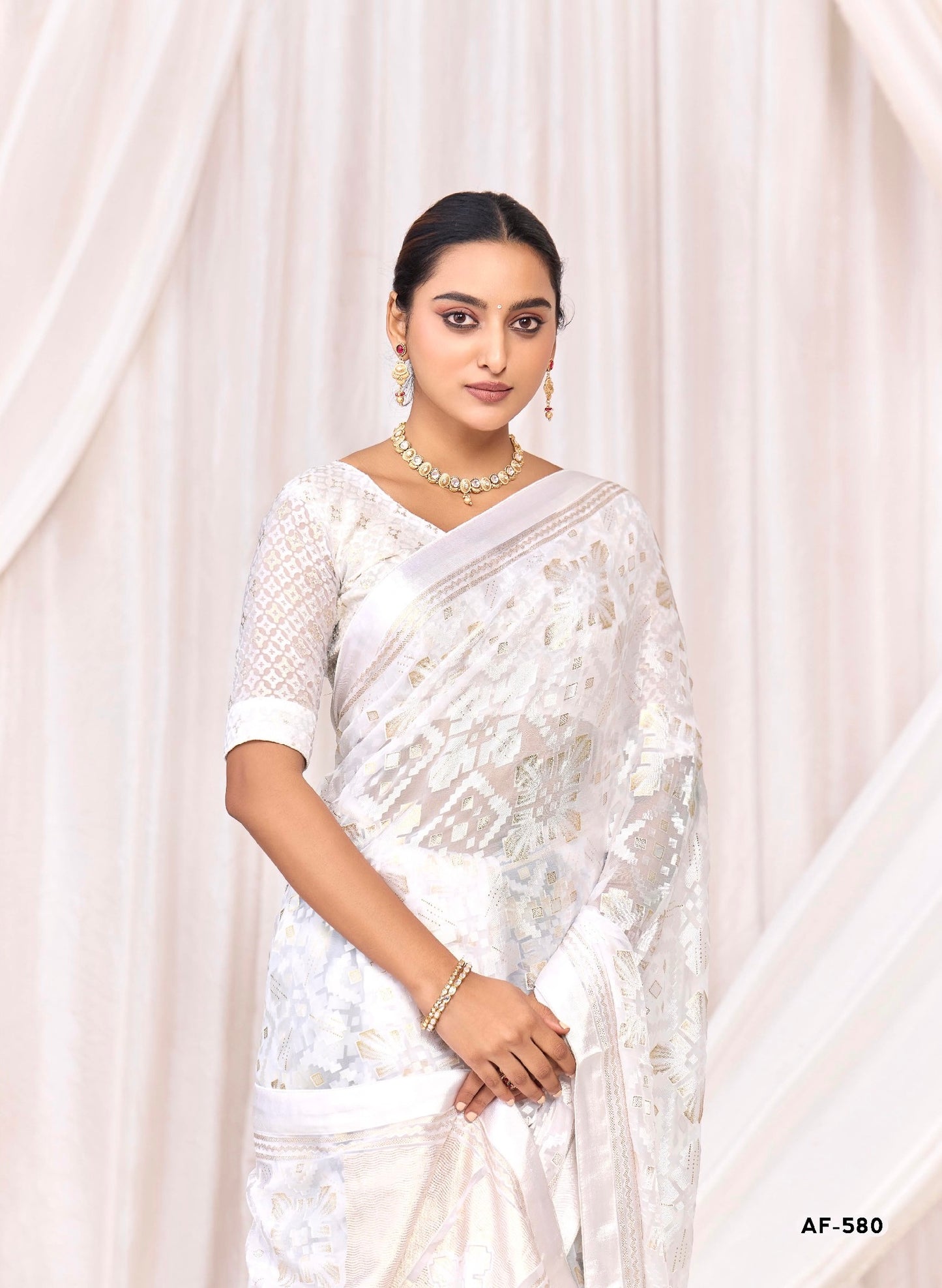 Pure Brasso fabric with Exclusive Off-White colored Designed with Featuring Interactive Silver Foil Touch with Rich Traditional Border Ideal for Day to Evening Events.