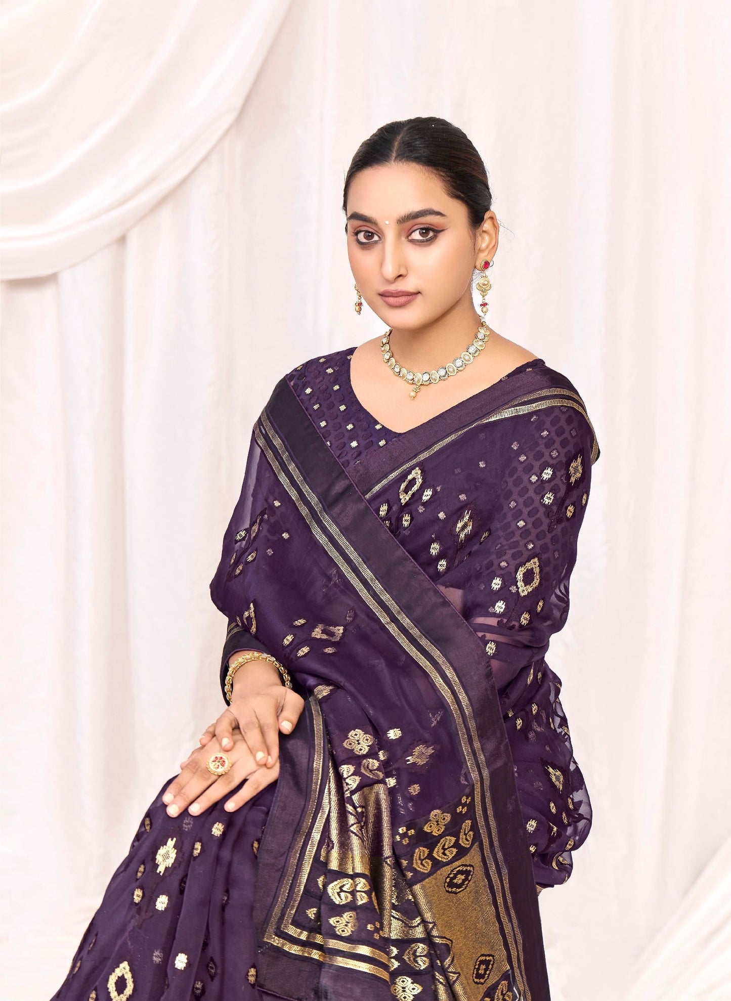 Pure Brasso fabric with Exclusive Deep Purple colored Designed with Featuring Interactive Gold & Silver Foil Touch with Rich Traditional Border Ideal for Day to Evening Events.