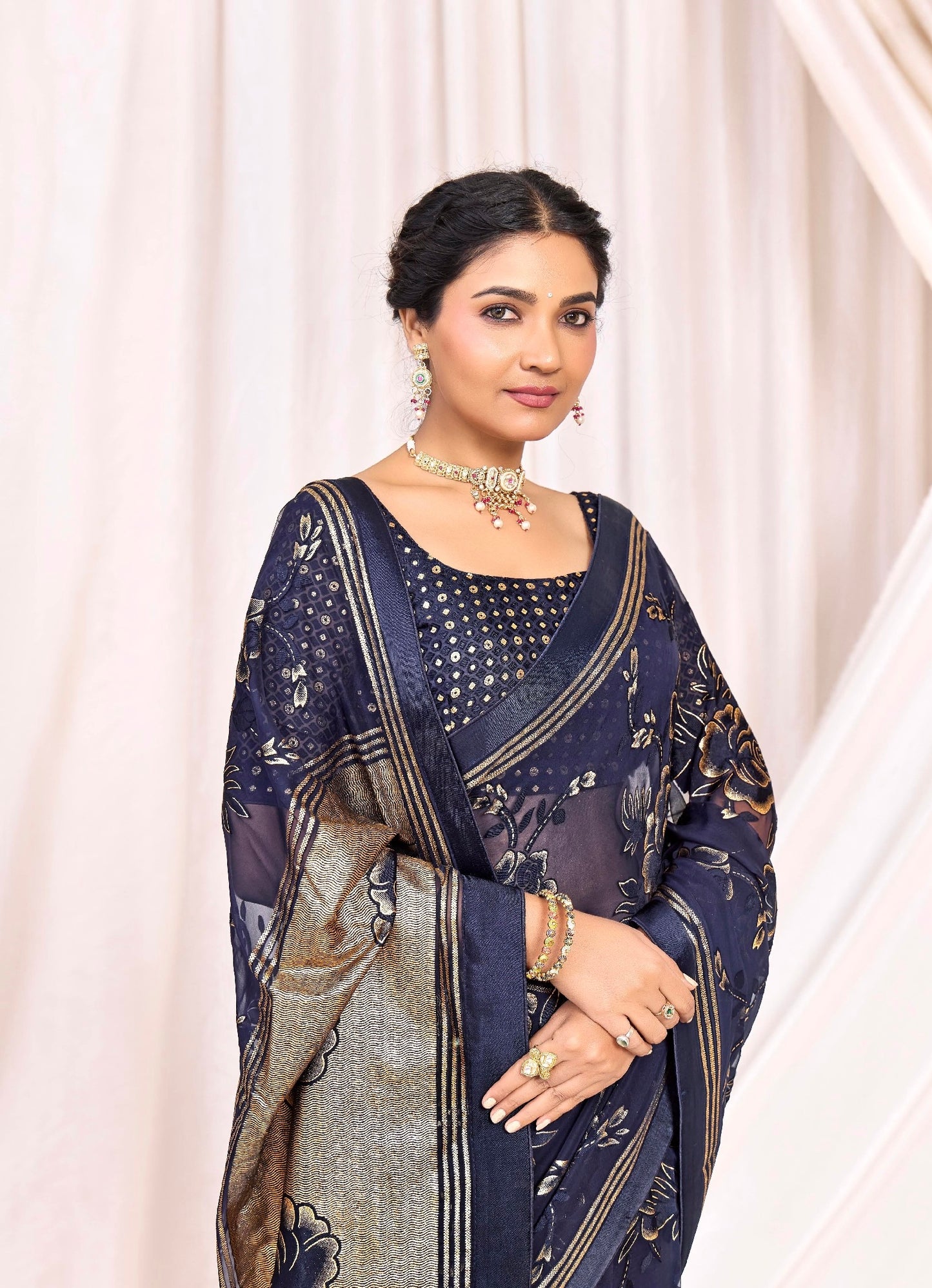 Pure Brasso fabric with Exclusive Deep Navy Blue colored Designed with Featuring Interactive Gold & Silver Foil Touch with Rich Traditional Border Ideal for Day to Evening Events.