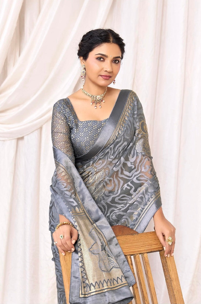 Pure Brasso fabric with Exclusive Metallic Grey colored Designed with Featuring Interactive Gold & Silver Foil Touch with Rich Traditional Border Ideal for Day to Evening Events.